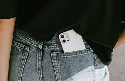 A white phone in the back pocket of a pair of jeans.