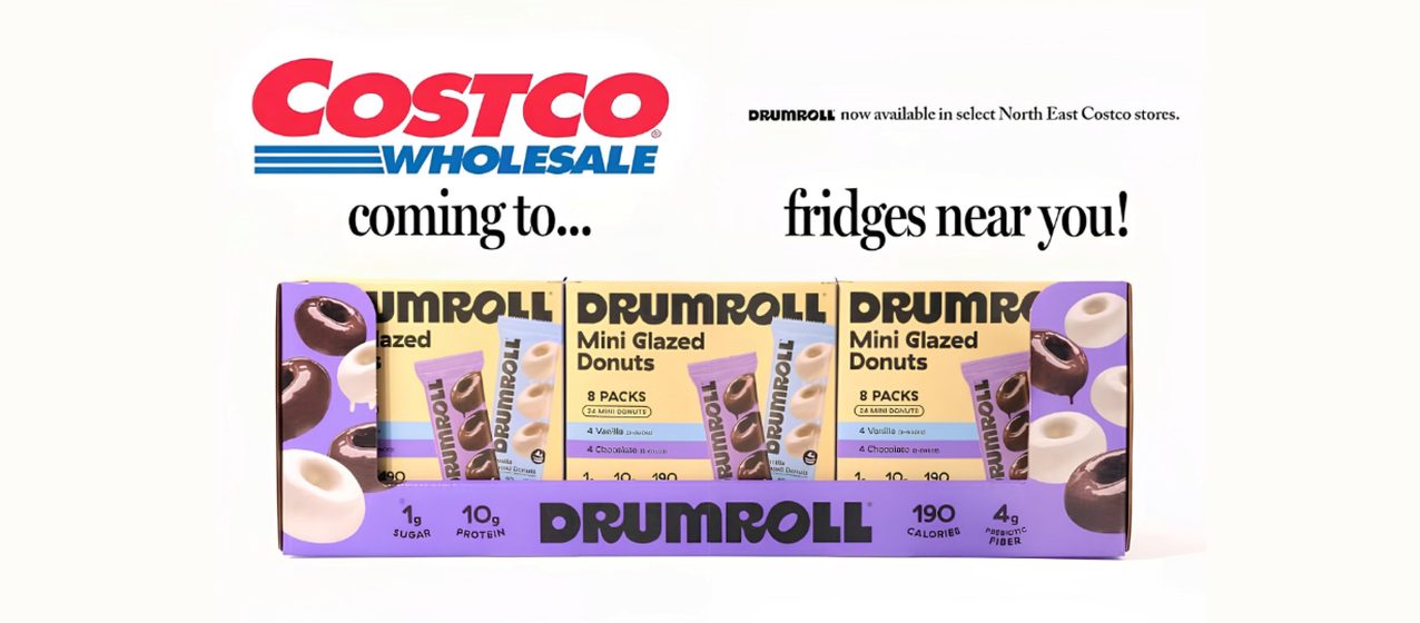Costco Wholesale announcement showing boxes of Drumroll mini glazed donuts coming to fridges in select Northeast stores.