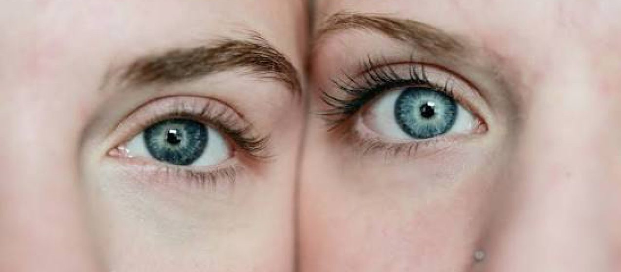 Close-up of a person's blue eyes looking straight at the camera.