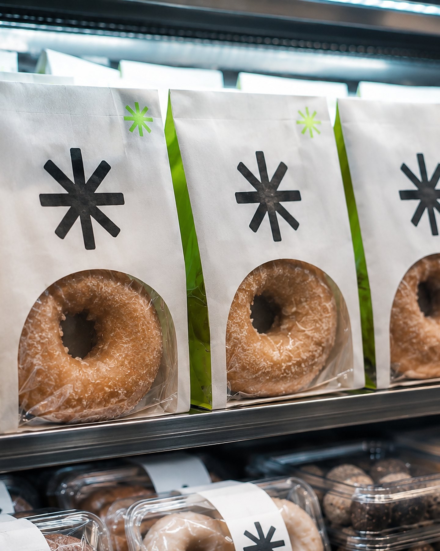 Anonymized packaged goods with asterisk marks in a refrigerated retail case